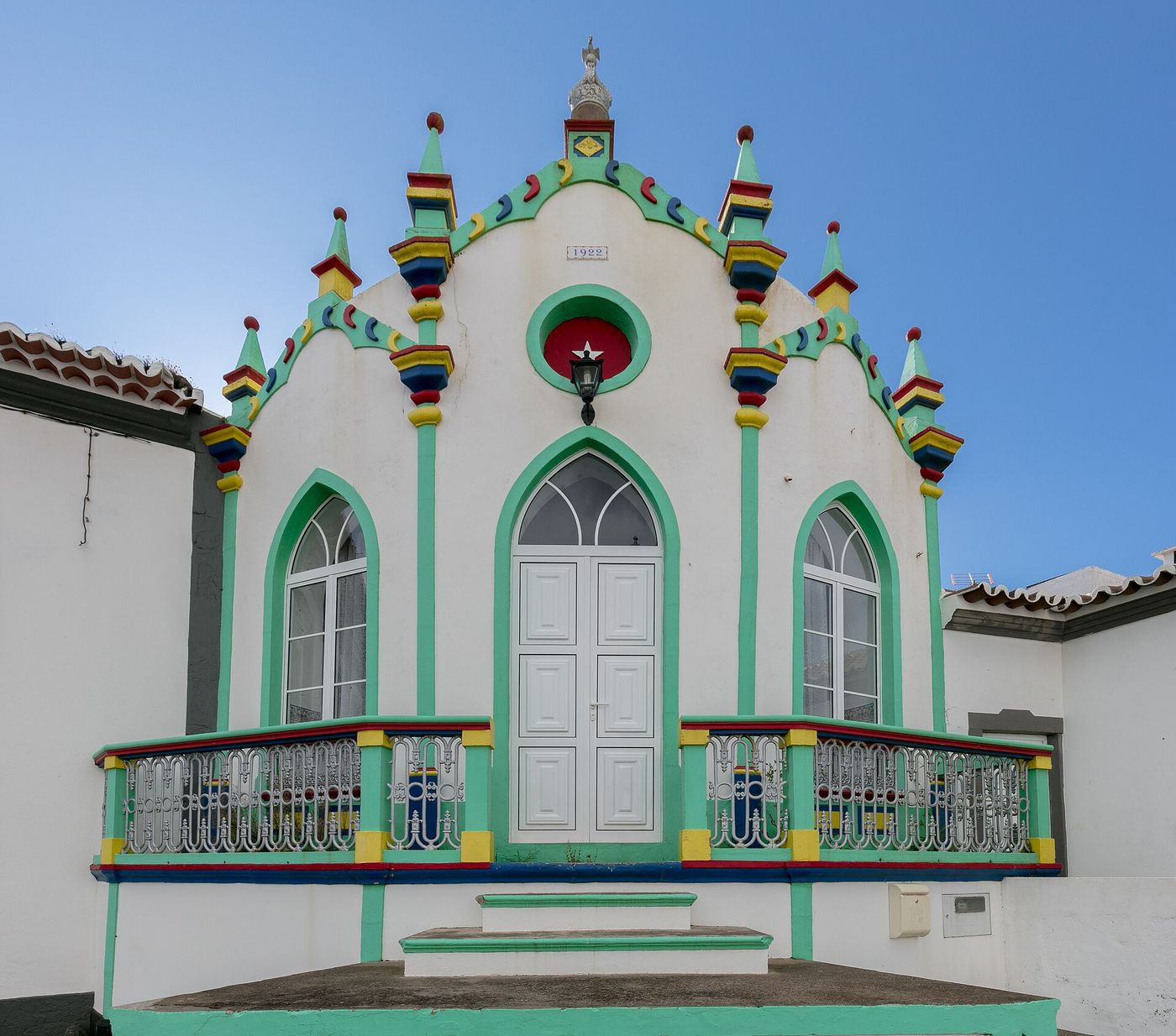 The brightly painted facade of a Holy Spirit imperio chapel on Terceira in the Azores