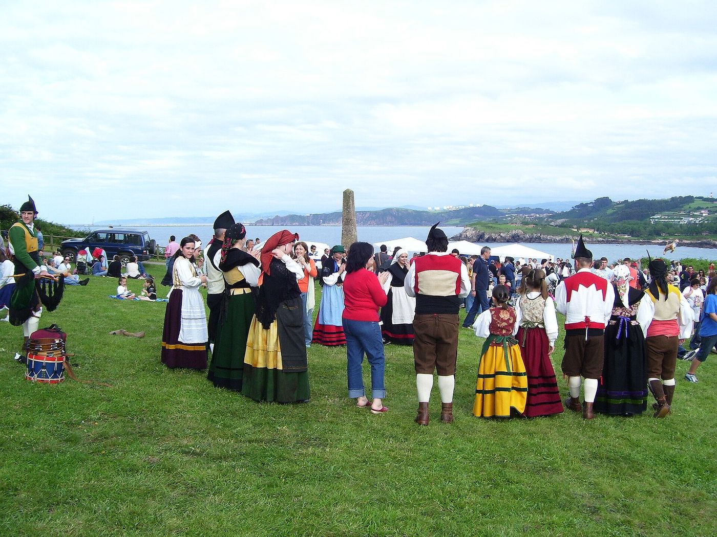 Asturian pipers and dancers in traditional dress at a coastal romeria above the sea at Candas